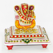 Marble ganesh idol sitting on chowki