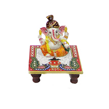 Ganesh statue sitting on chowki