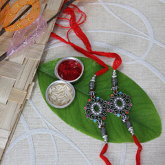 Black Metal Rakhi Set /></a></div><div class=