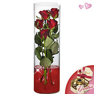 5 roses in glass vase with Lindt chocolates